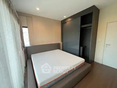 Modern bedroom with sleek design and built-in closet, featuring a comfortable bed and stylish decor.