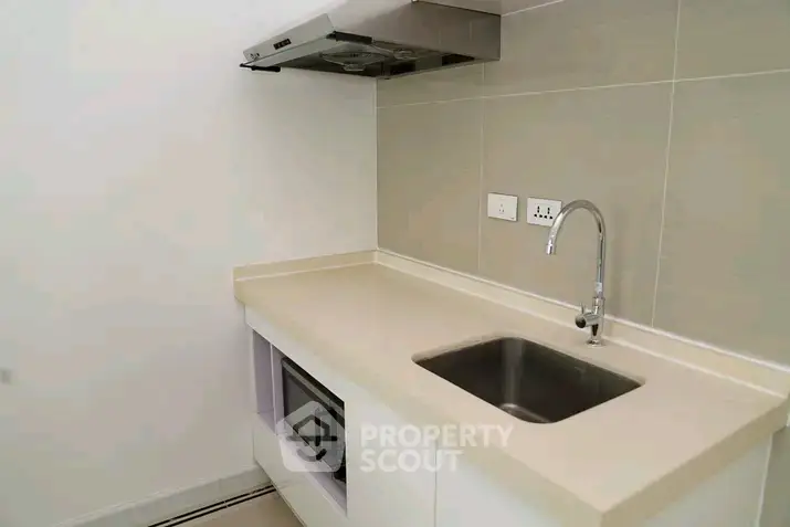 Modern kitchen with sleek countertop and built-in appliances in a minimalist design.