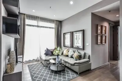 Elegant living room with modern decor, featuring a stylish sectional sofa and floor-to-ceiling windows.