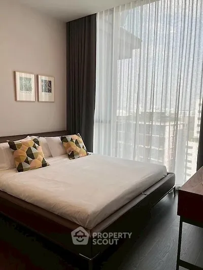 Modern bedroom with large window and stylish decor in urban apartment