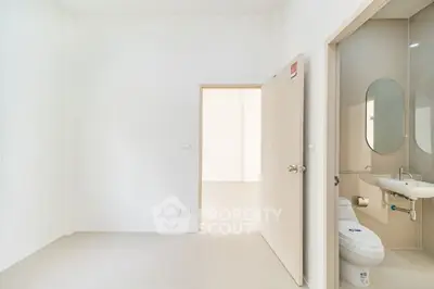 Minimalist bathroom with modern fixtures and neutral tones, perfect for a sleek and clean look.