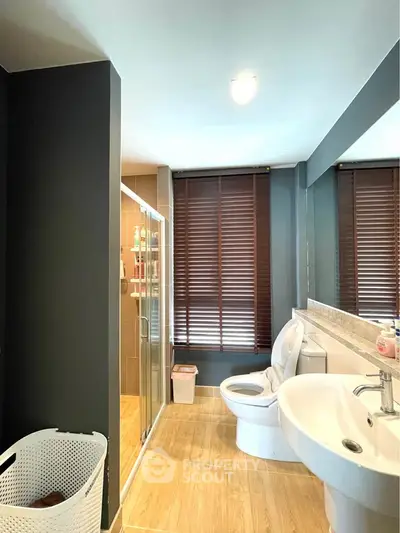 Modern bathroom with sleek design, featuring a glass shower and stylish fixtures.