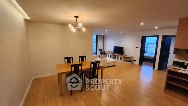 Spacious open-plan living and dining area with modern furnishings and ambient lighting.