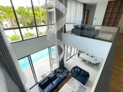 Luxurious modern living room with high ceilings and pool view, featuring elegant furniture and large windows.