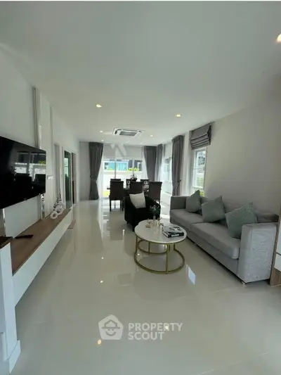 Spacious modern living room with sleek design and ample natural light, perfect for relaxation and entertainment.