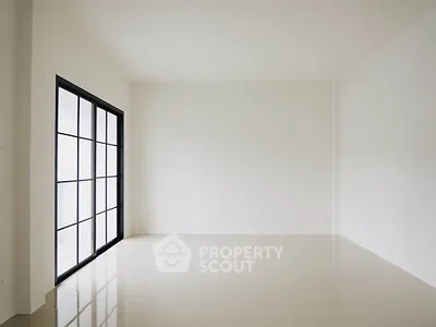 Spacious empty room with large windows and glossy tiled floor, perfect for customization.