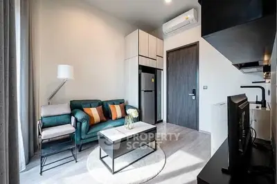 Modern living room with stylish furniture and open kitchen layout in a cozy apartment.