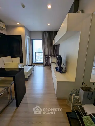 Modern living room with sleek furniture and city view balcony