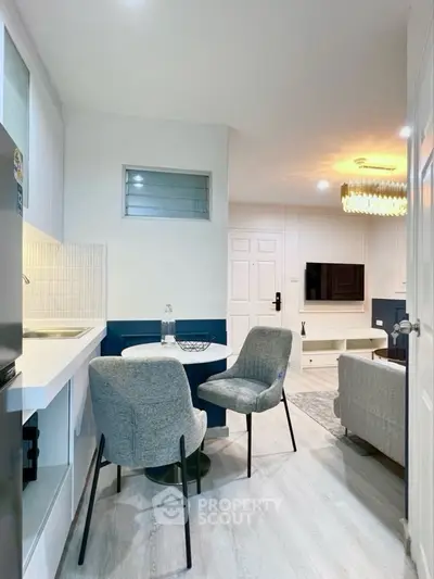 Modern living room with stylish furniture and open kitchen layout, perfect for cozy urban living.