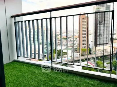 Stunning city view from a modern balcony with artificial grass flooring, perfect for relaxation.