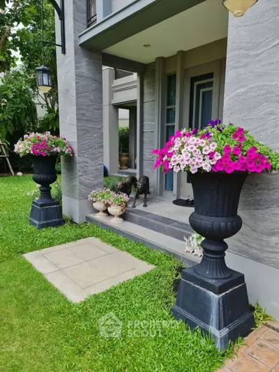 Charming home entrance with elegant flower arrangements and lush greenery