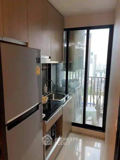 Modern kitchen with sleek appliances and city view from window