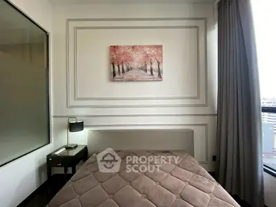 Cozy bedroom with elegant decor and large window offering city views, perfect for relaxation and comfort.