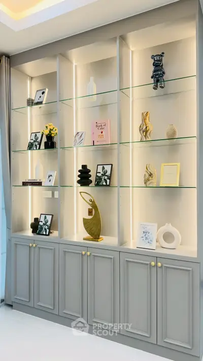 Elegant built-in shelving with decorative items in a modern living room setting.