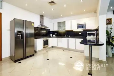 Modern kitchen with sleek appliances and open layout in luxury home