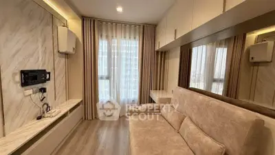 Modern living room with elegant decor and natural light, featuring a cozy sofa and stylish wall-mounted TV.
