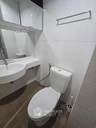 Modern bathroom with sleek white tiles and contemporary fixtures