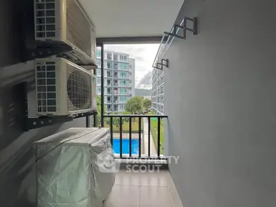 Modern balcony with pool view in urban apartment complex