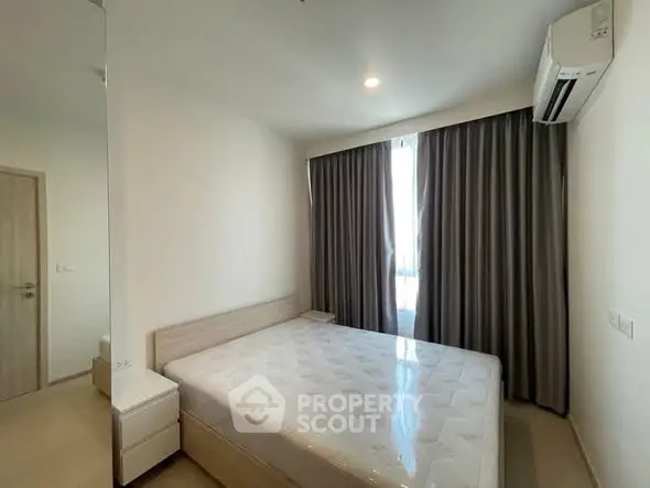 Modern minimalist bedroom with natural light and air conditioning