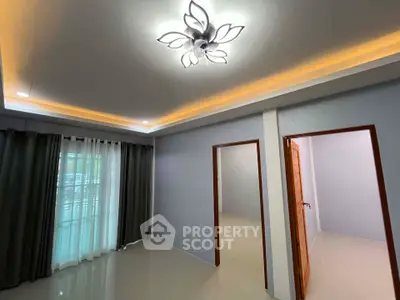 Spacious modern living room with elegant lighting and large windows for natural light.