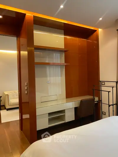 Elegant bedroom with built-in desk and warm wood accents