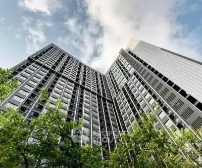 Stunning high-rise building with modern architecture and lush greenery