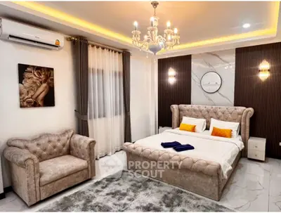 Luxurious bedroom with elegant decor, featuring a plush bed, stylish armchair, and ambient lighting.