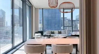 Luxurious modern living room with floor-to-ceiling windows and city view.