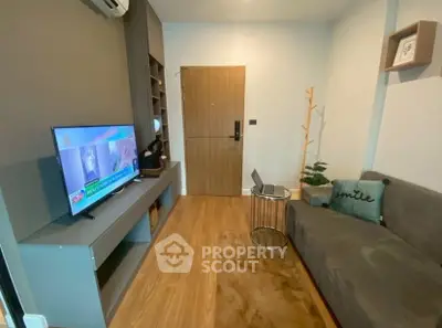 Cozy living room with modern decor, TV, and stylish furniture, perfect for relaxation.