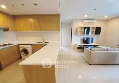 Spacious open layout living room and kitchen with modern appliances and stylish furnishings.