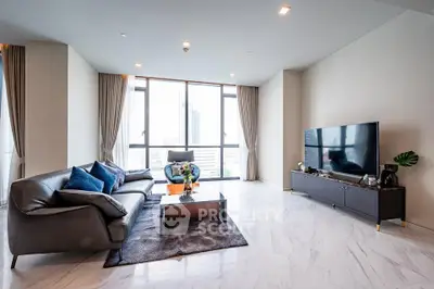 Luxurious modern living room with large windows and elegant decor in high-rise apartment.
