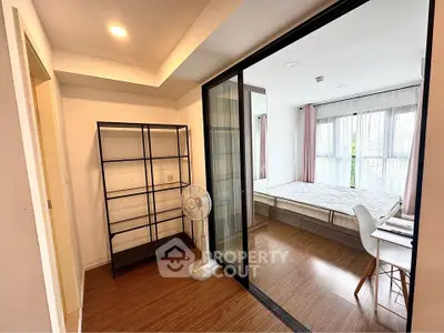 Modern bedroom with sliding glass doors and natural light