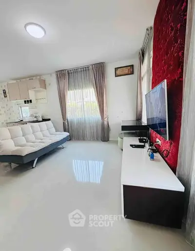 Modern living room with sleek furniture and large windows for natural light.