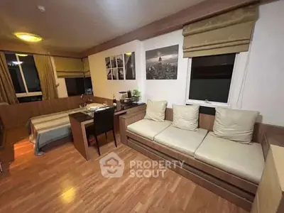 Cozy studio apartment with modern decor and wooden flooring