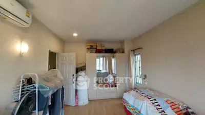 Spacious and well-lit bedroom with modern amenities, ample storage space, and a cozy bed, perfect for comfortable living.