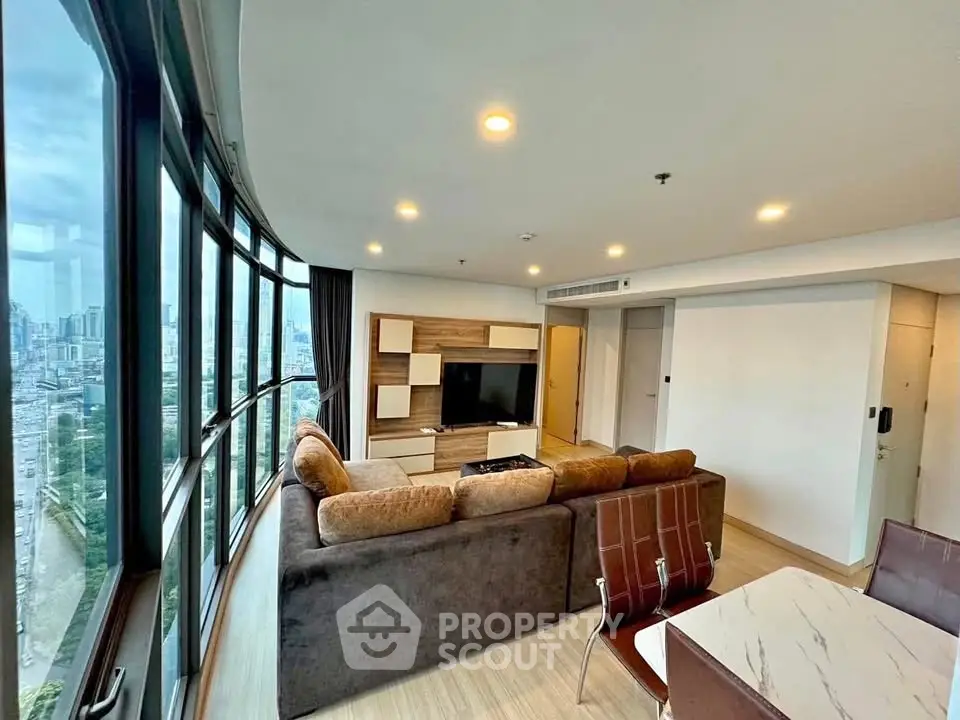 Spacious living room with panoramic city view and modern furnishings