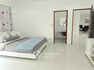 Spacious modern bedroom with ensuite bathroom and sleek decor