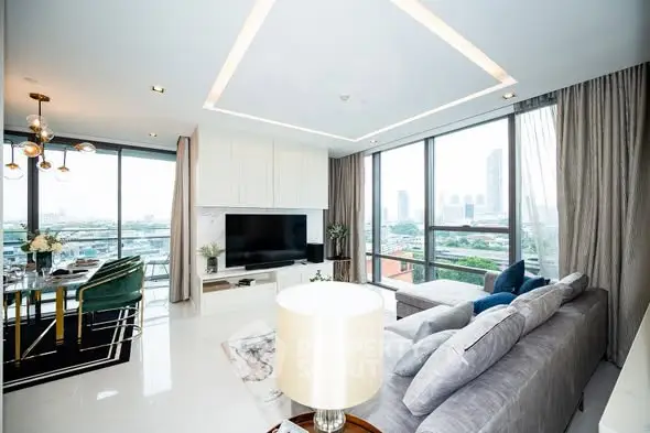 Luxurious modern living room with panoramic city views and elegant decor.