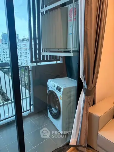 Modern apartment balcony with washing machine and city view