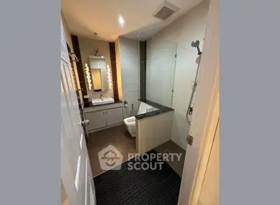 Modern bathroom with glass shower and stylish lighting