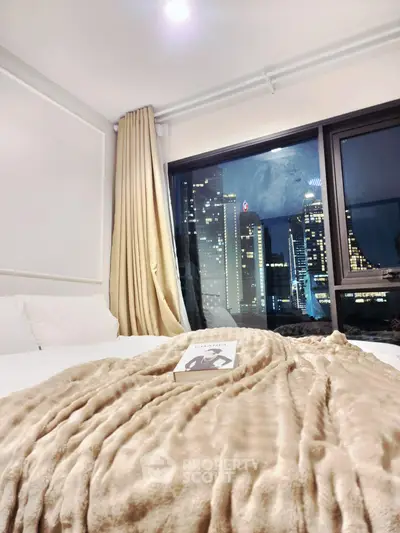 Luxurious bedroom with stunning city skyline view, cozy bedding, and elegant curtains.