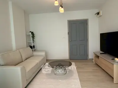 Modern living room with cozy sofa and stylish decor in a bright apartment.
