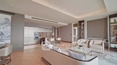 Luxurious open-plan living room with elegant furniture and modern kitchen in a high-end apartment.