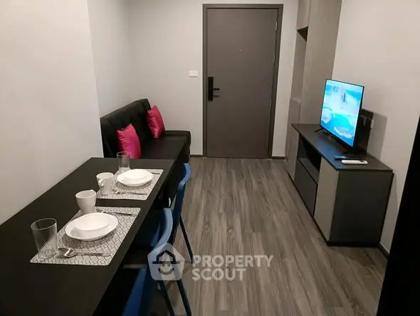 Modern compact living room with dining area and TV setup