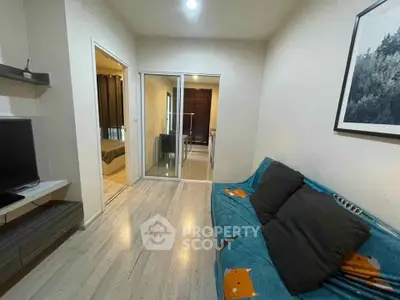 Cozy living room with modern decor and adjacent bedroom view