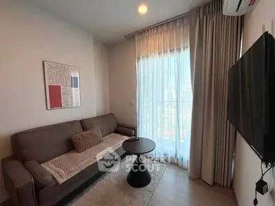 Modern living room with cozy sofa, stylish decor, and large window with city view.