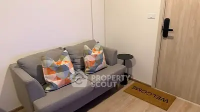 Cozy living room with modern sofa and stylish decor in a welcoming apartment.