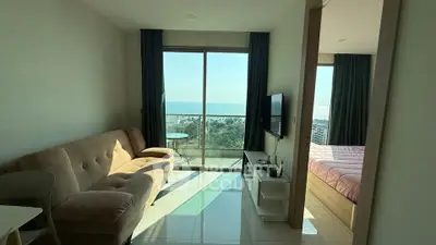 Modern living room with ocean view and cozy bedroom in a stylish apartment