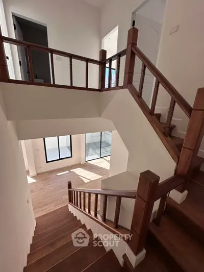 Elegant wooden staircase in modern home with natural light and stylish design