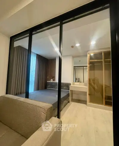 Modern bedroom with glass partition and cozy decor